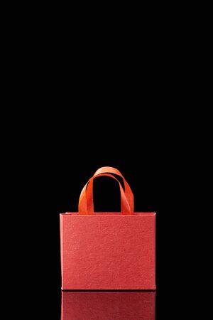 paper red shopping bag with handle isolated on blackの写真素材