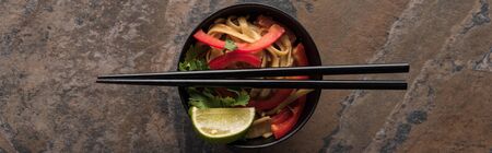 top view of thai noodles and chopsticks on stone surface, panoramic shotの写真素材