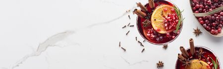 panoramic shot of christmas cocktails with orange, pomegranate, cinnamon and frozen  cranberryの写真素材