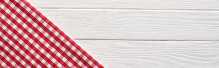 top view of checkered red napkin at white wooden table, panoramic shotの写真素材