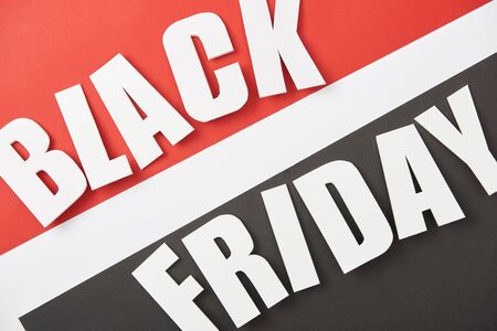 top view of black friday lettering on black, white and red backgroundの写真素材