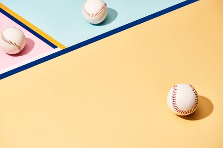 White baseball balls on colorful background with linesの写真素材