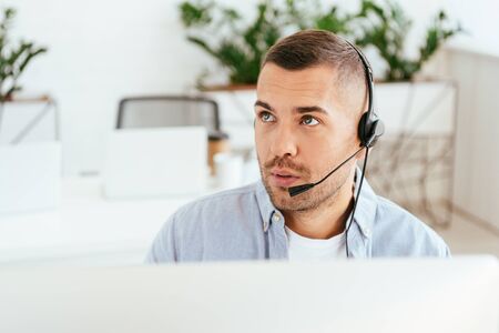 selective focus of surprised operator in brokers agency