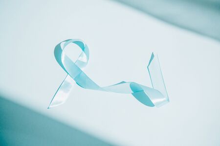 blue awareness ribbon on white background with shadowsの写真素材