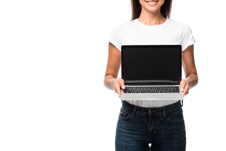 cropped view of woman showing laptop with blank screen, isolated on whiteの写真素材