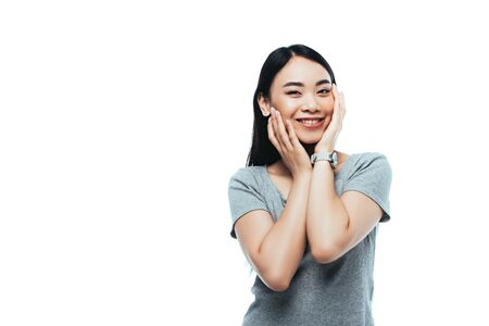 happy asian girl touching face isolated on whiteの写真素材