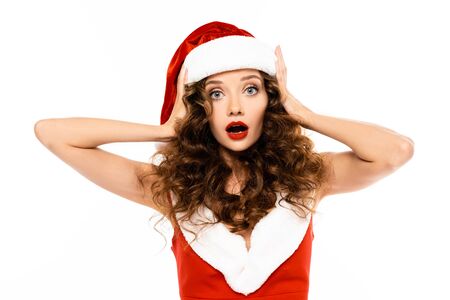 beautiful shocked girl posing in santa costume, isolated on whiteの写真素材
