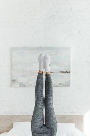 cropped view of girl doing morning exercise in bedroomの写真素材