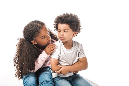 attentive african american sister calming down upset brother isolated on whiteの写真素材