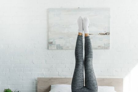 partial view of woman doing morning exercise in bedroomの写真素材