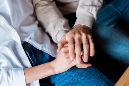 cropped view of man and holding holding handsの写真素材