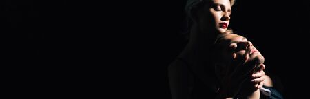 panoramic shot of attractive woman hugging handsome man with closed eyesの写真素材