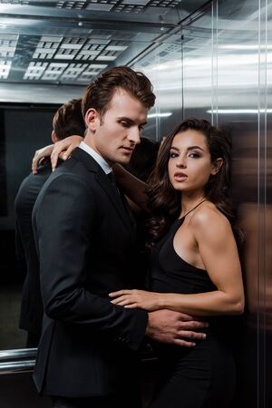 beautiful sexy couple hugging and flirting in lift
