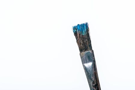 close up of paintbrush with blue paint isolated on whiteの写真素材