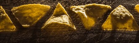 flat lay with delicious crispy corn nachos on wooden rustic table, panoramic shotの写真素材