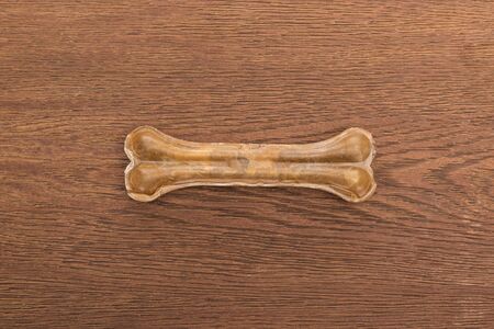 top view of pet bone on wooden tableの写真素材