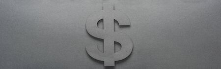 top view of dollar sign on grey background with shadow, panoramic shotの写真素材