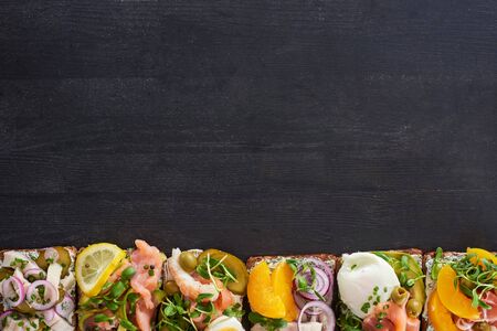 top view of traditional prepared smorrebrod sandwiches on grey surfaceの写真素材