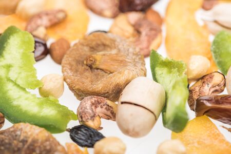close up view of Turkish assorted nuts, dried fruits and candied fruit isolated on whiteの写真素材