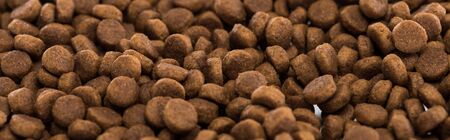 brown dry pet food background with copy space, panoramic shot