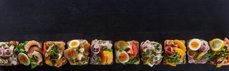 panoramic shot of fresh danish smorrebrod sandwiches on grey surfaceの写真素材