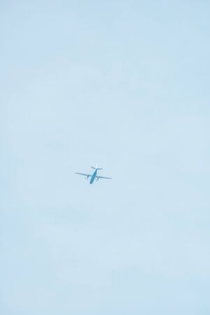 Bottom view of airplane with blue sky at backgroundの写真素材