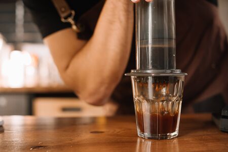 partial view of barista preparing coffee with aeropressの写真素材