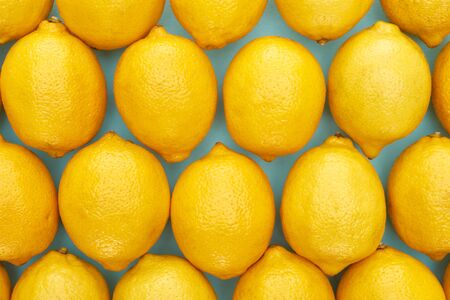 top view of ripe yellow lemons on blue backgroundの写真素材