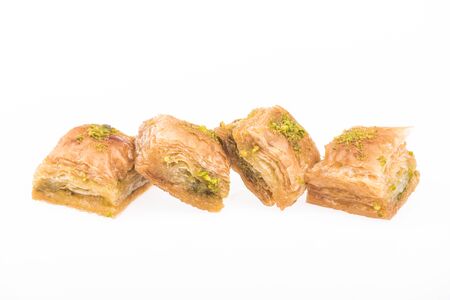row of traditional turkish honey baklava with nuts isolated on whiteの写真素材