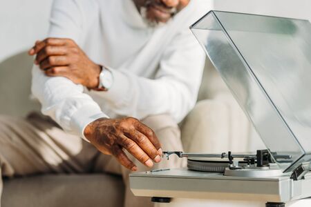 cropped view of african american man near record playerの写真素材