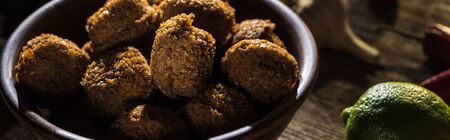 delicious falafel balls near lime on wooden rustic table, panoramic shotの写真素材