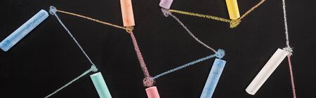 top view of colorful chalk on black surface with connected drawn lines, connection and communication...