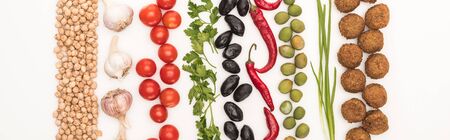 top view of chickpea, garlic, cherry tomatoes, parsley, olives, chili pepper, green onion and...