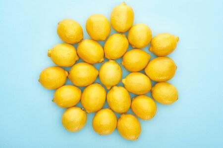 top view of ripe yellow lemons on blue backgroundの写真素材