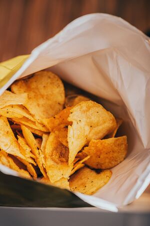 close up view of delicious crispy potato chips in packageの写真素材