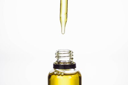 bottle and dropper with natural serum isolated on white