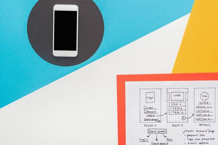 top view of smartphone near website design template on abstract background
