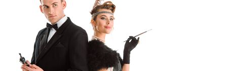 panoramic shot of handsome man holding gun near attractive woman isolated on white