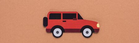 top view of paper cut car on brown background, car rent concept
