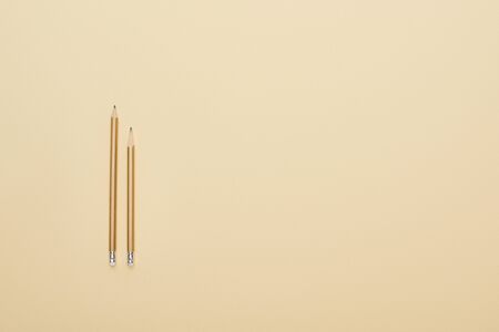 flat lay with wooden pencils on beige background