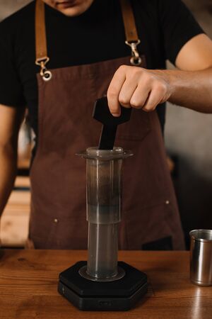 cropped view of barista preparing coffee with aeropressの写真素材