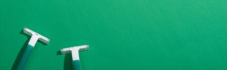 top view of green disposable razors on green background, panoramic shotの写真素材