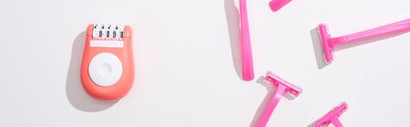 top view of female pink razors and epilator on white background, panoramic shot