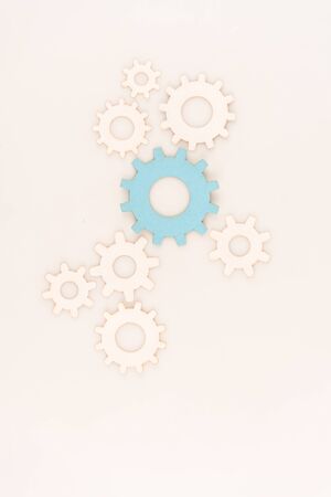 top view of one blue gear among another isolated on whiteの写真素材