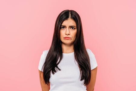 sad beautiful girl isolated on pinkの写真素材