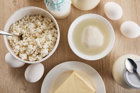 top view of fresh organic dairy products and eggs on wooden tableの写真素材