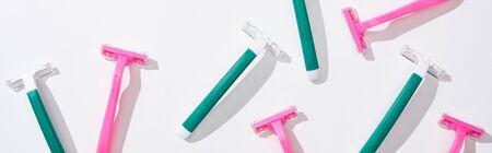 flat lay with green disposable razors on white background