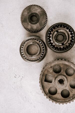 top view of aged metal round gears on grey backgroundの写真素材