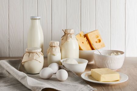 delicious fresh dairy products and eggs on white wooden backgroundの写真素材