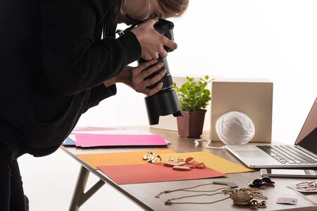 photographer taking photo of composition with flora and accessories for commercial photo shooting with camera and laptopの写真素材